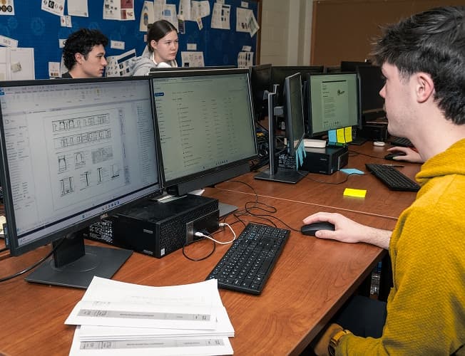 Student working at dual monitors in a university computer lab
