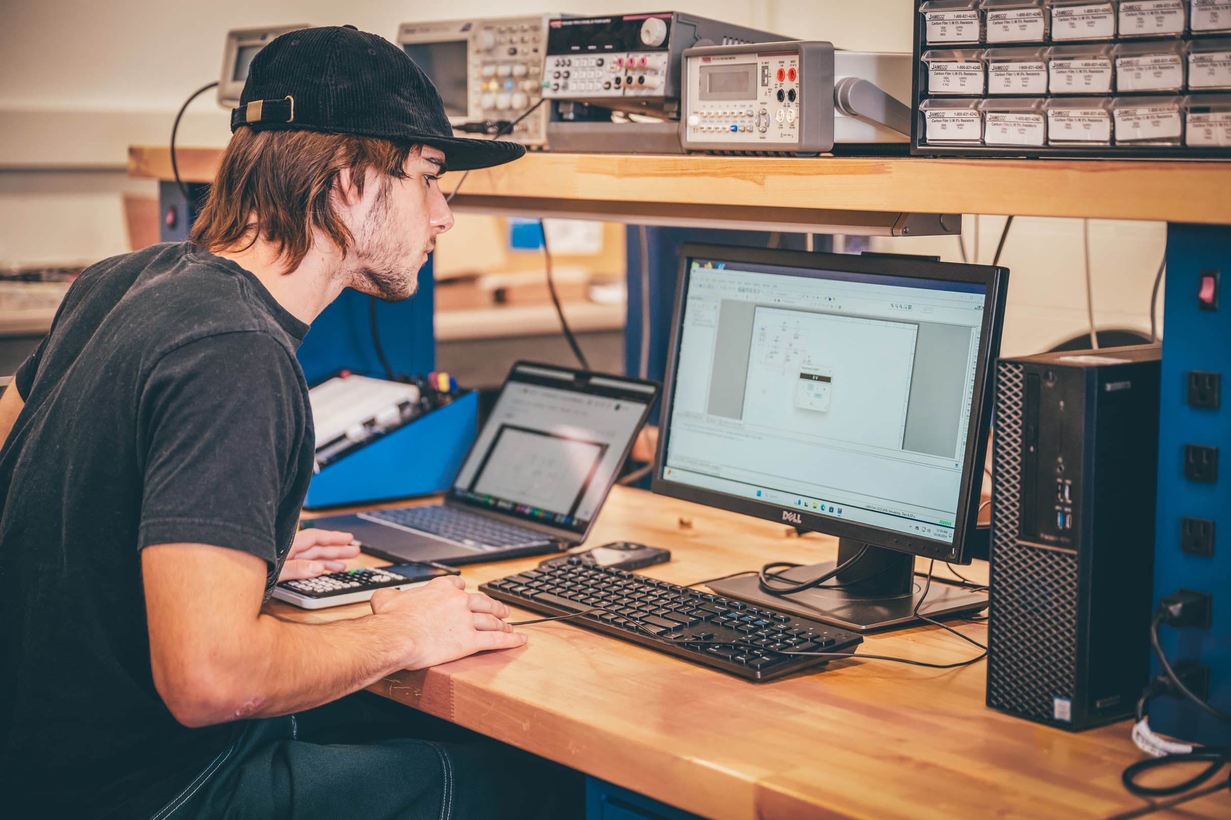 Student reviewing a circuit simulation in an electronics lab