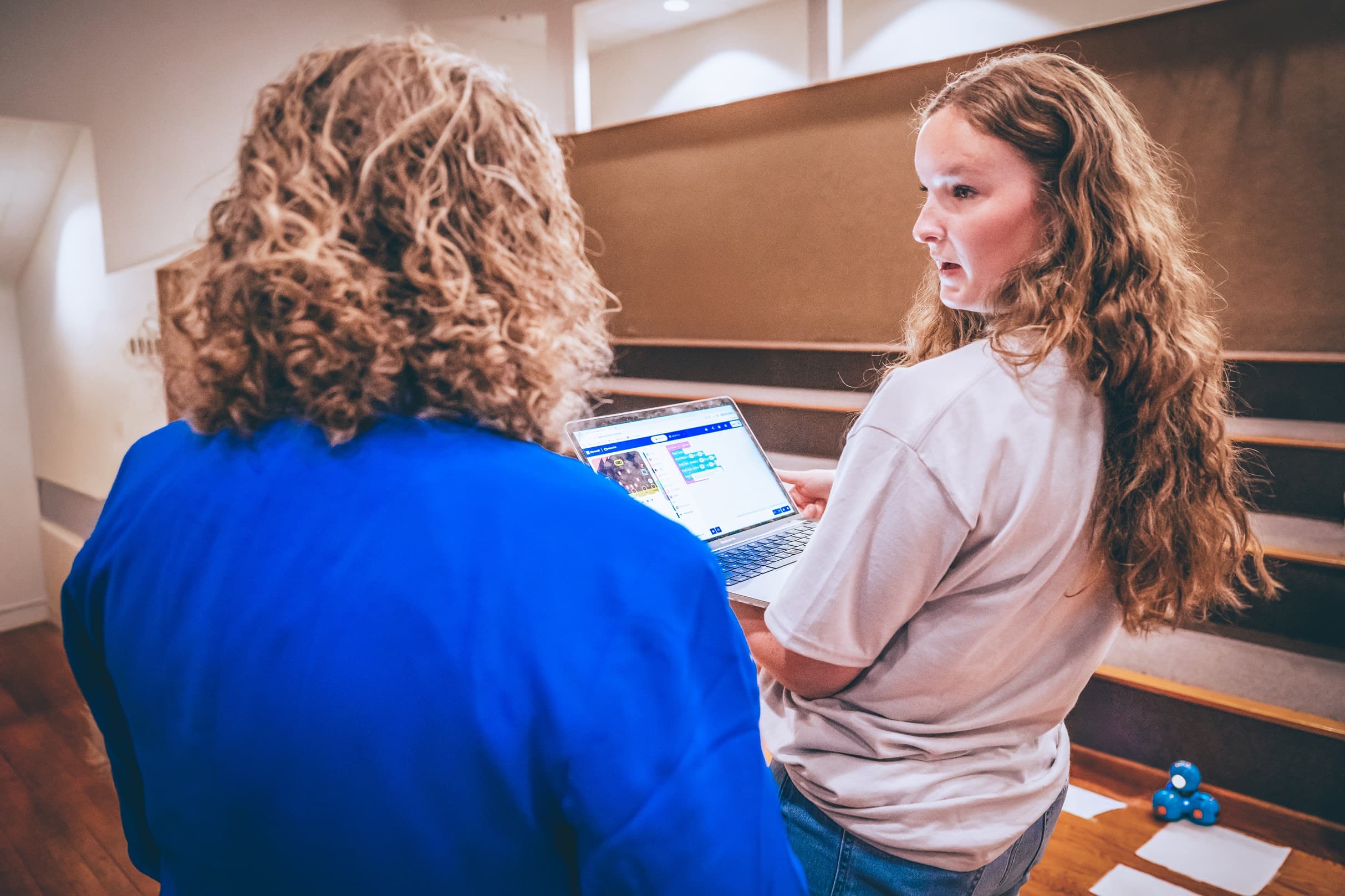 Students working together on a coding project with a robotics toy