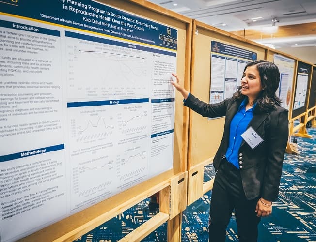 ETSU researcher presenting a reproductive health policy poster