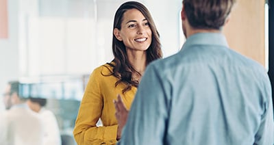 Male and female colleagues having a conversation